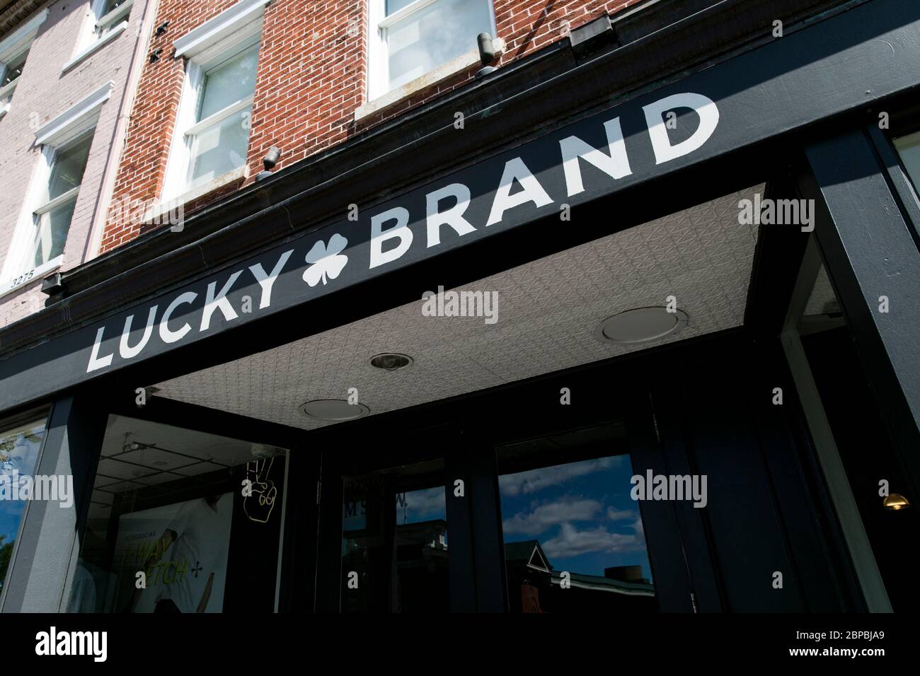 A logo sign outside of a Lucky Brand Jeans retail store location in Washington, D.C., on May 9, 2020. Stock Photo