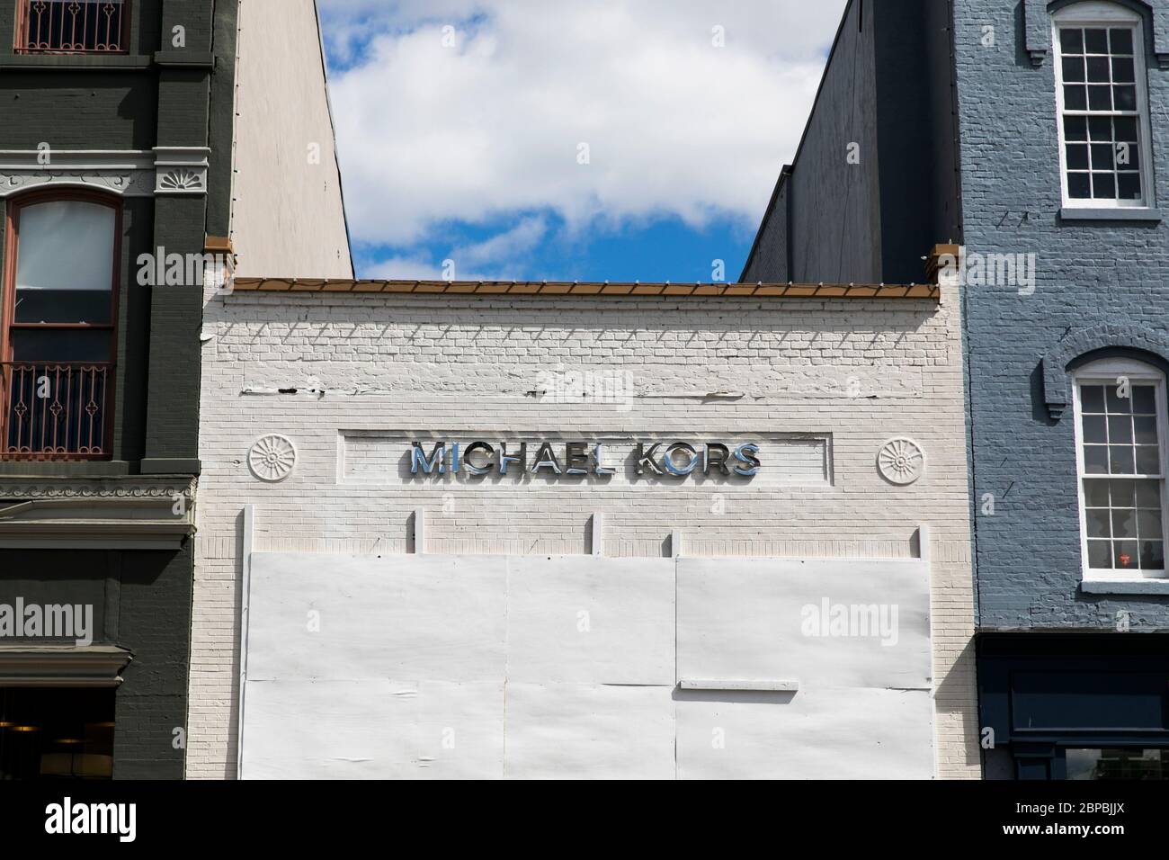 A logo sign outside of a boarded up and closed Michael Kors retail store  location in Washington, ., on May 9, 2020 Stock Photo - Alamy