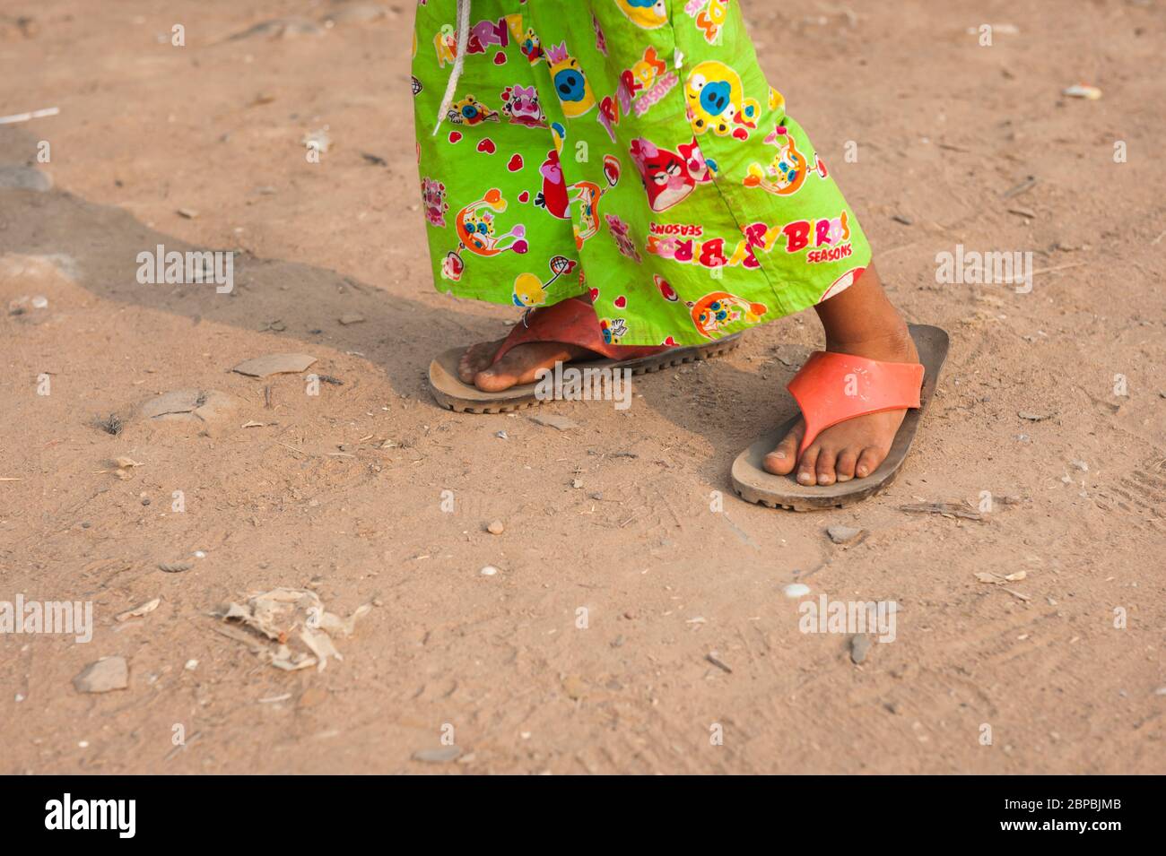 A young Cambodian boy with oversized clothes.  Kampong Phluk, Siem Reap Province, Northern-central Cambodia, Southeast Asia Stock Photo