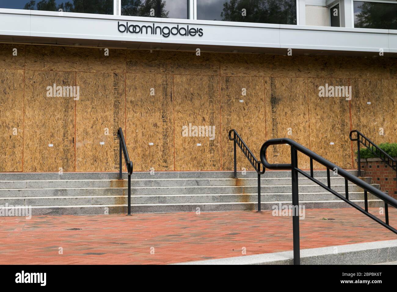 A logo sign outside of a boarded up and closed Bloomingdale's retail store location in Chevy Chase, Maryland on May 9, 2020. Stock Photo