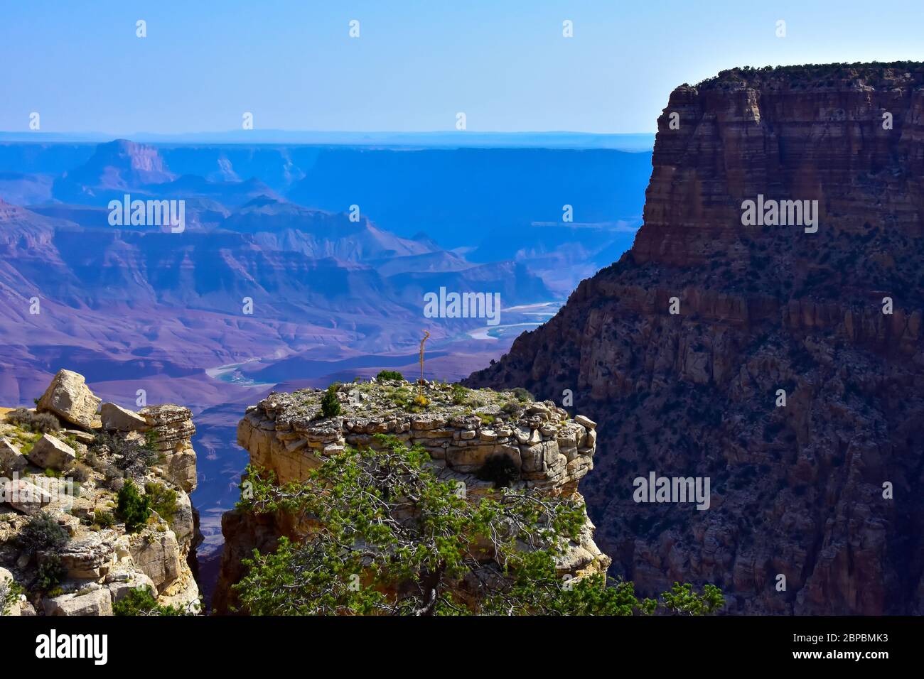 Beautiful colorful view of the south rim of the Grand Canyon in Arizona. In the far distance, you can see the colorado river on the canyon floor. Stock Photo