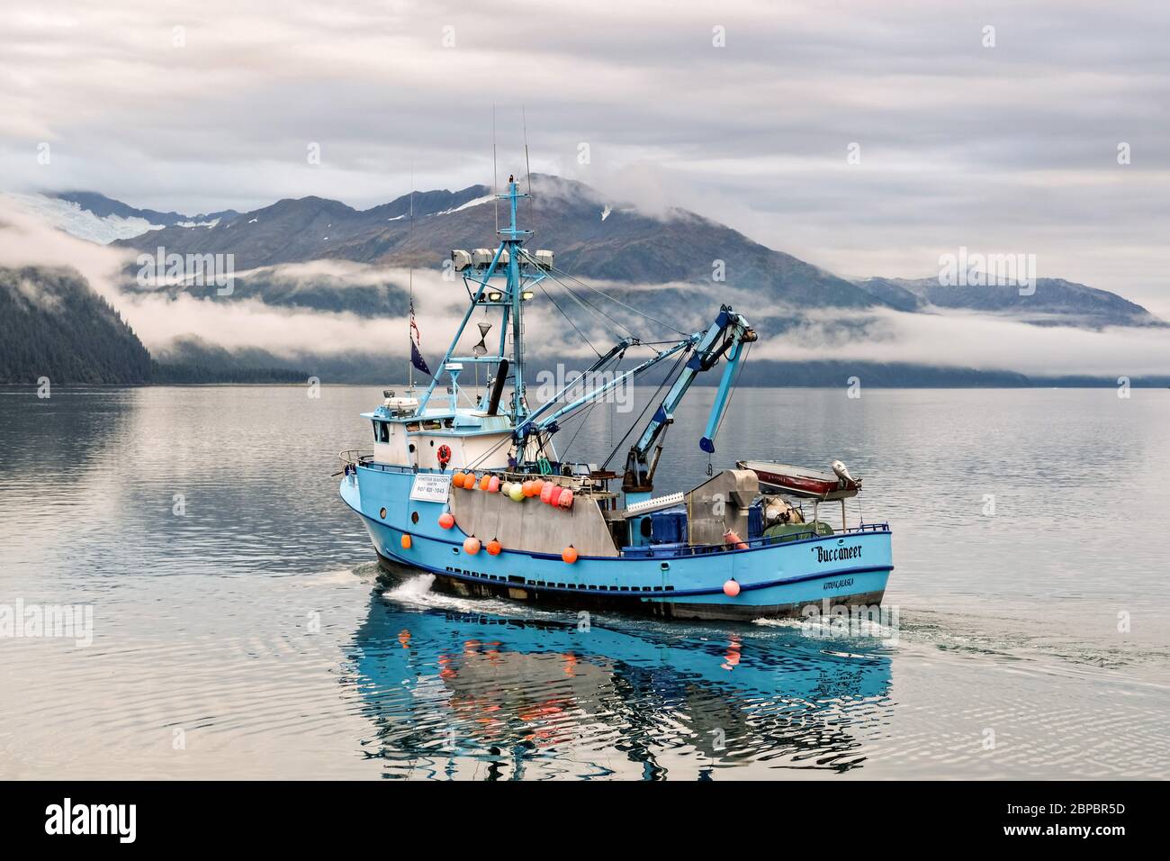 A commercial fishing boats heads out on the Passage Canal in