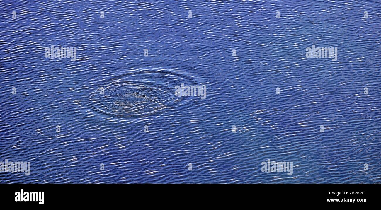 concentric circles in a blue water of lake Stock Photo Alamy