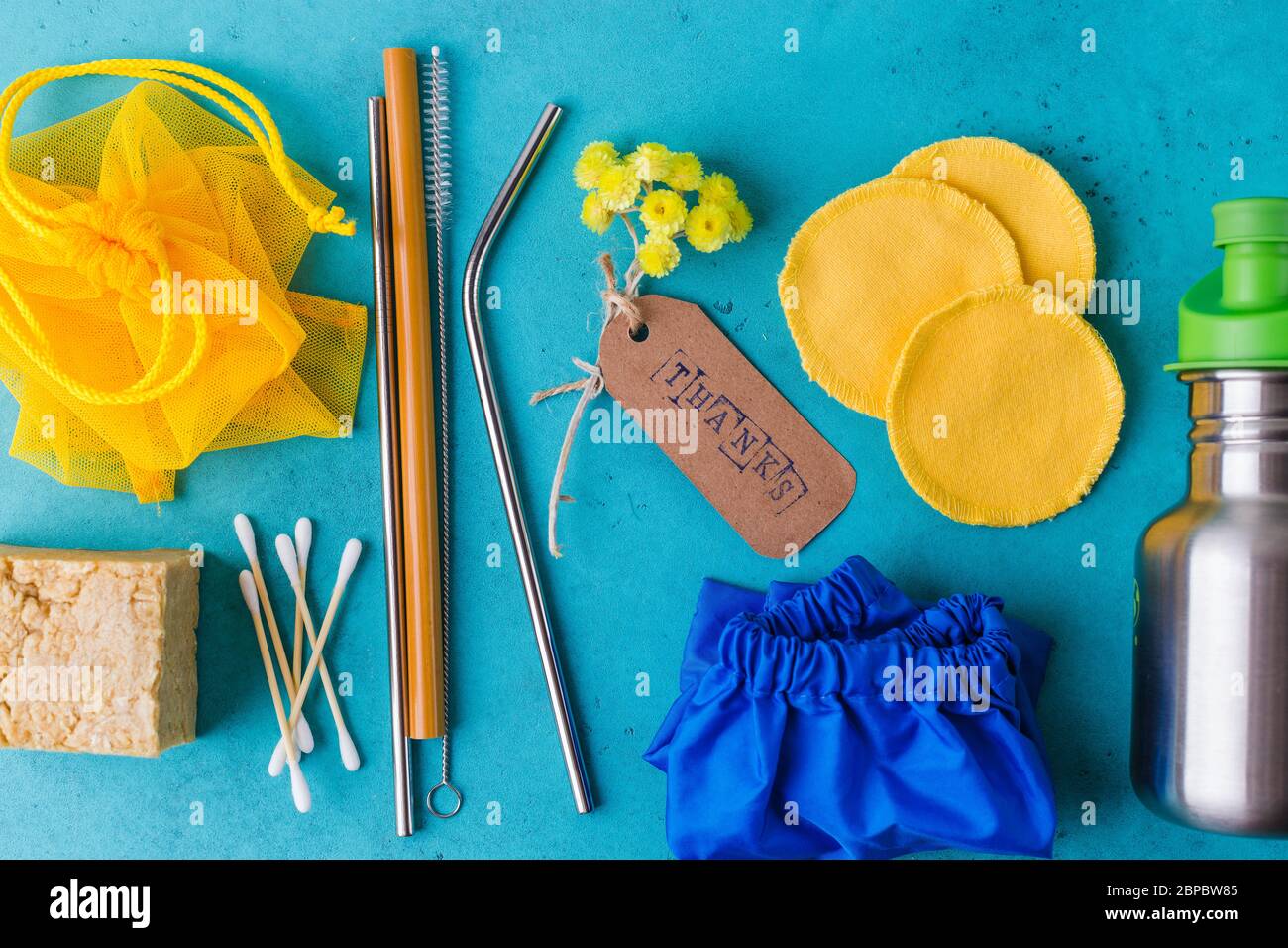 Zero Waste Things.Reusable things for eco life: bottle, bamboo straw and ear stick, shoe covers, mesh bag, cotton pad Stock Photo