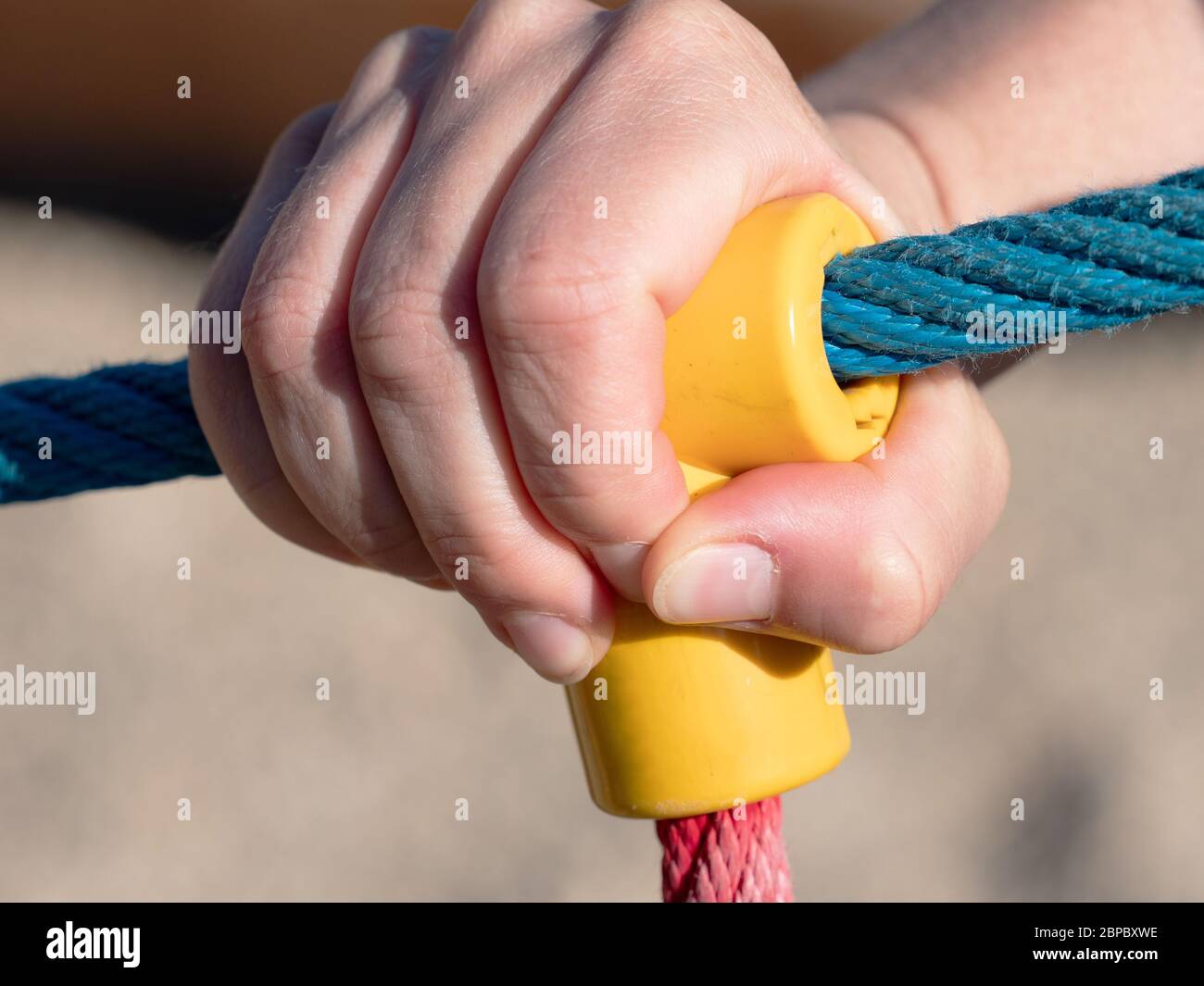 Hands tying rope around wood Stock Photo - Alamy