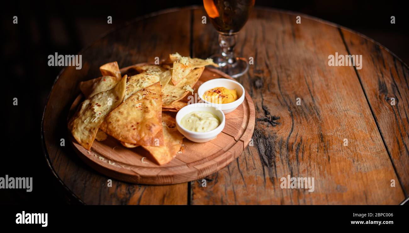 crispy fresh tortilla chips with sauces Stock Photo
