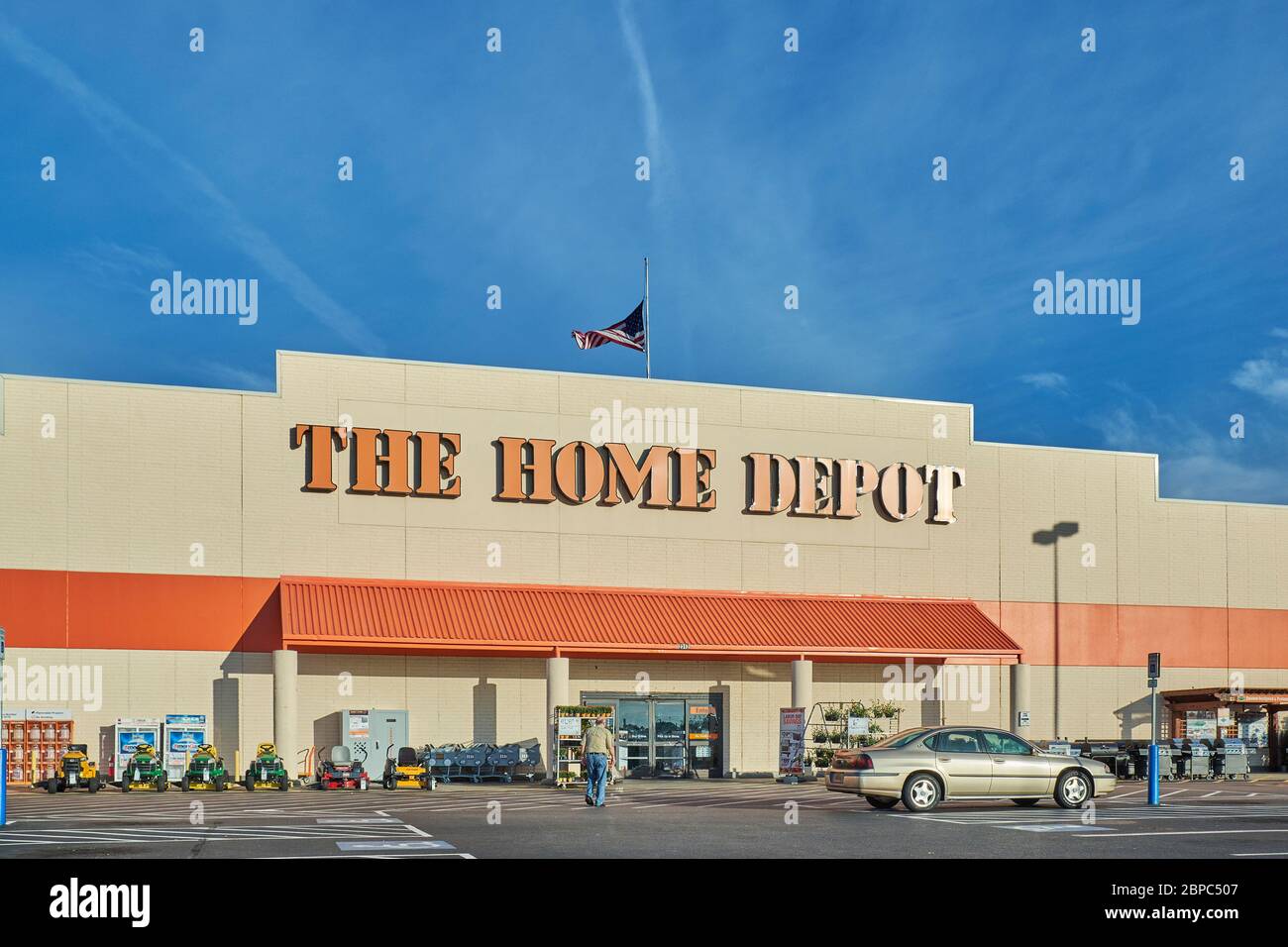 Customer entering Home Depot home improvement store, and big box store, showing the sign and logo in Montgomery Alabama, USA. Stock Photo