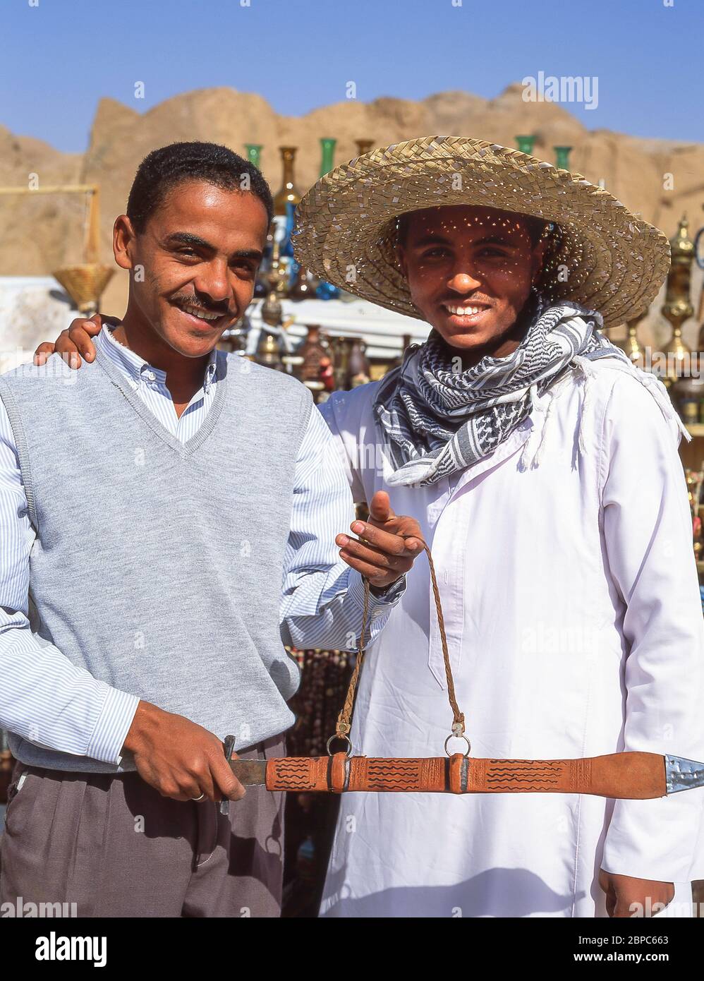 Local stall holders holding local sword, Aswan, Aswan Governorate, Republic of Egypt Stock Photo