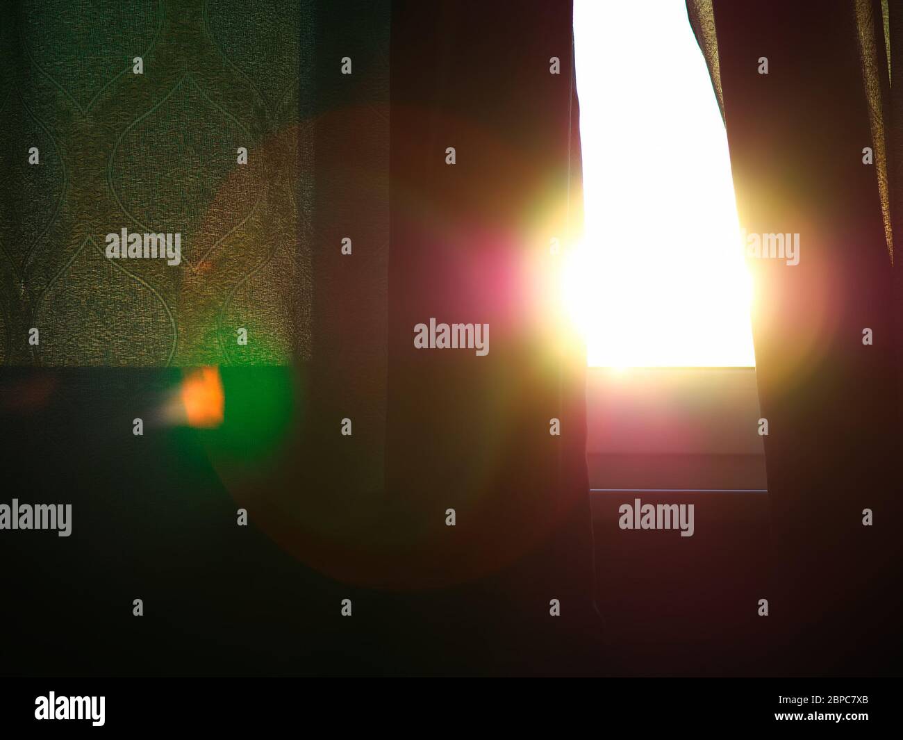 Dramatic light leak through green curtain background Stock Photo - Alamy