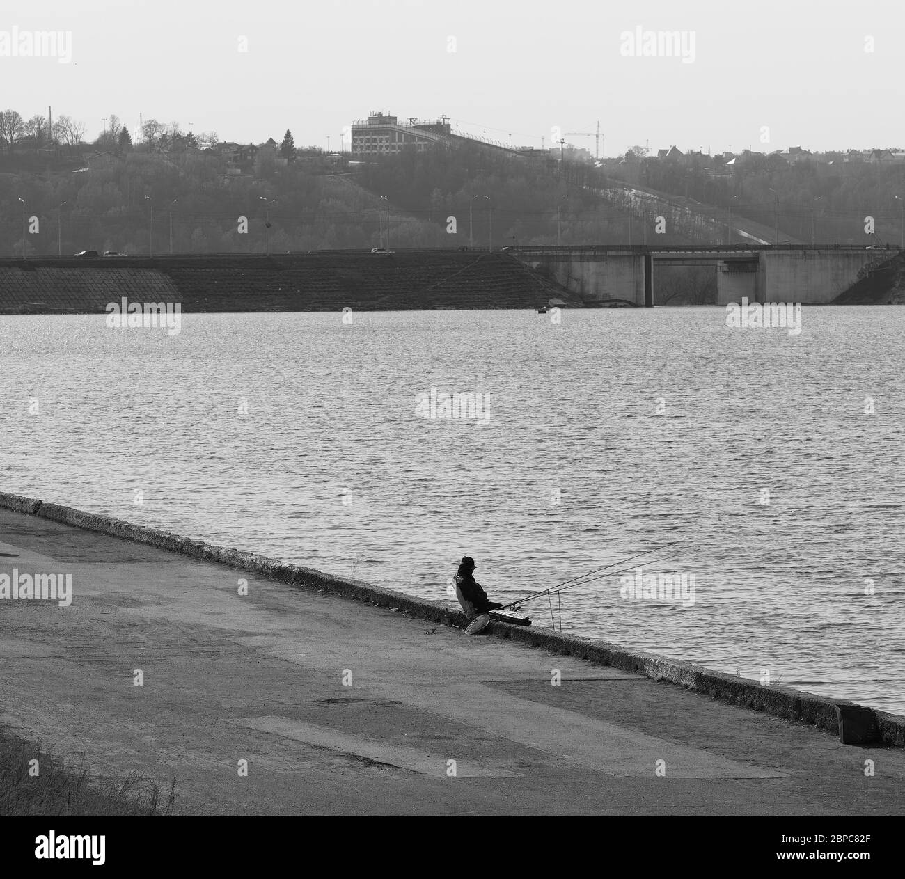 Fisherman on river bank background Stock Photo Alamy