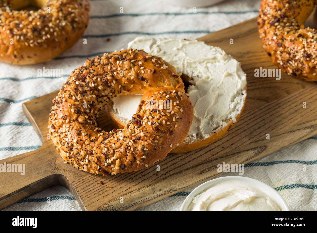 Homemade Toasted Everything New York Bagel with Cream Cheese Stock Photo