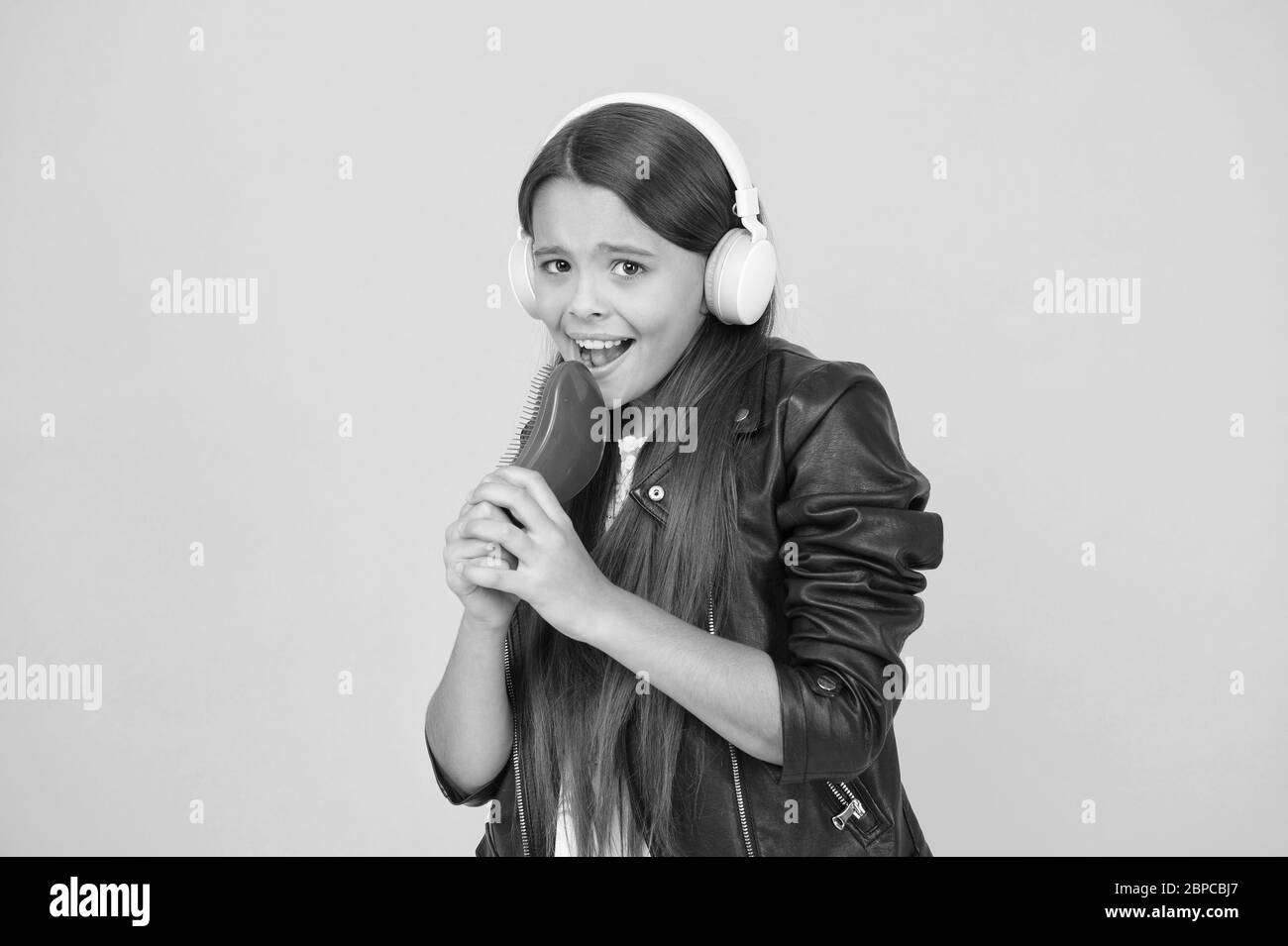 Singing into hairbrush Black and White Stock Photos & Images - Alamy