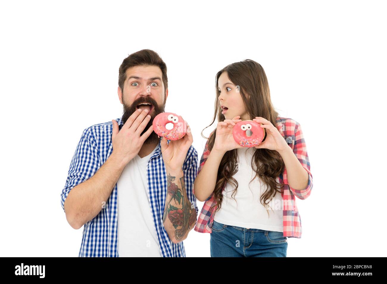 Delicious is what you deserve. Surprised family eat donuts. Little child and father enjoy delicious dessert. Bake shop. Bakery and cafe. Delicious medicine for depression. Stock Photo