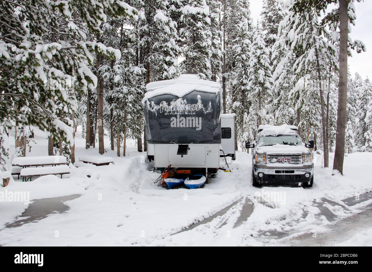 A mid May snowfall covers an RV and truck in Yellowstone National Park, USA Stock Photo