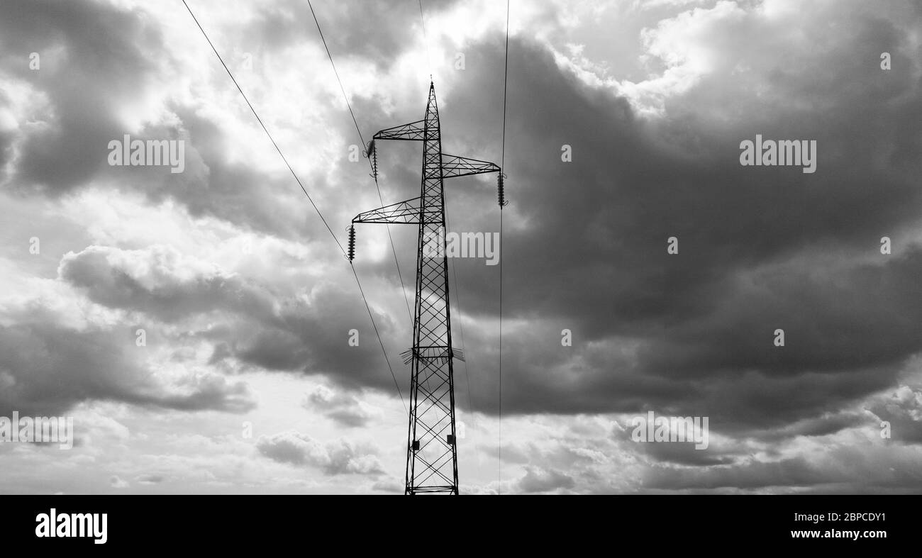 Cloudy sky over an electric pylon, monochrome photo Stock Photo - Alamy