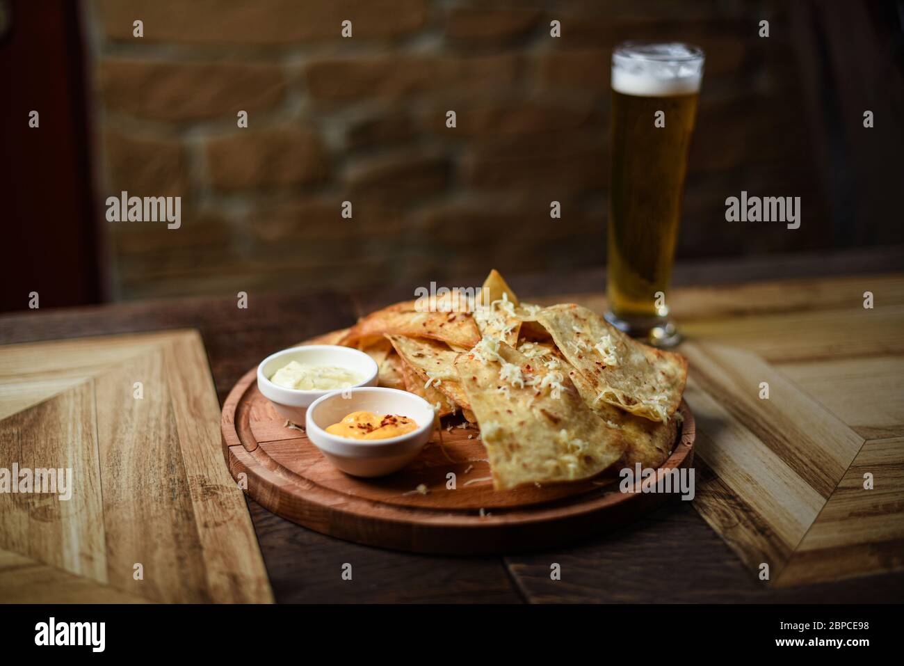crispy fresh tortilla chips with sauces Stock Photo