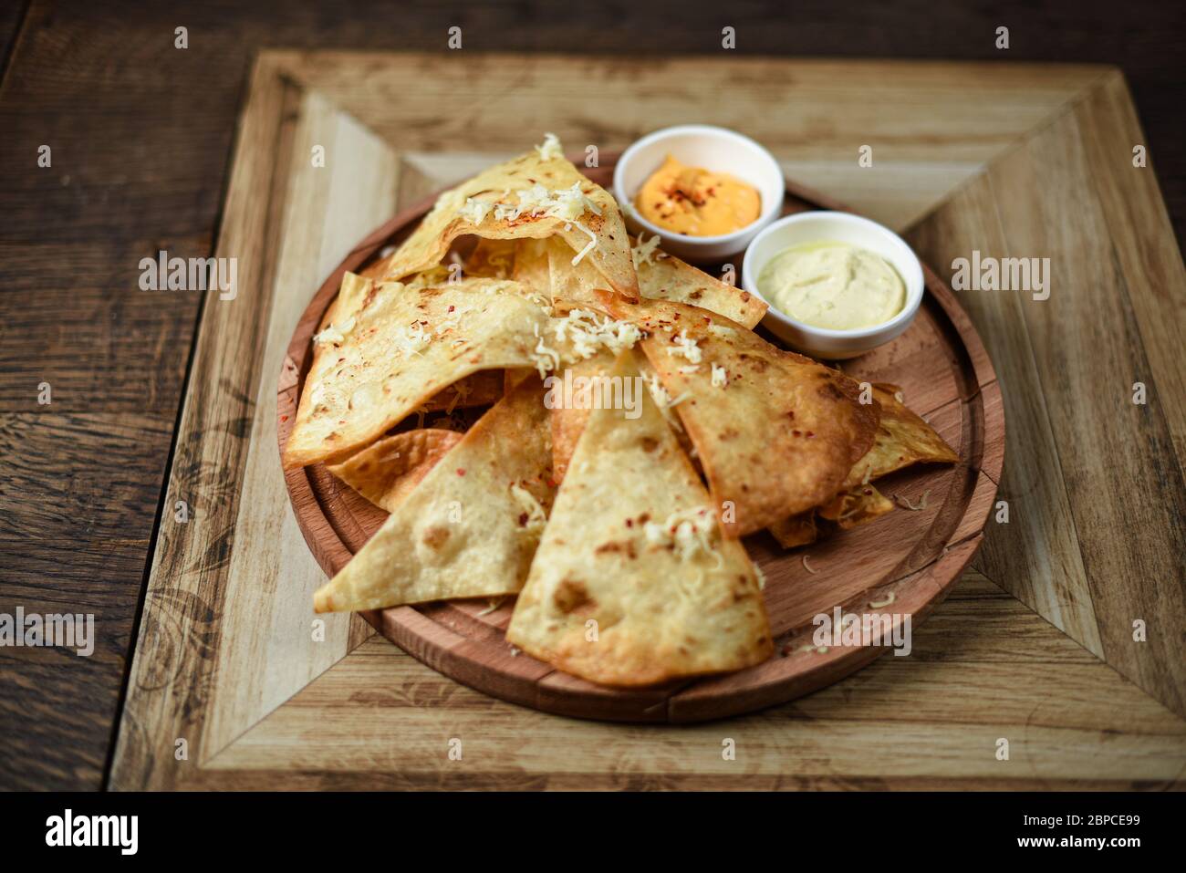 crispy fresh tortilla chips with sauces Stock Photo