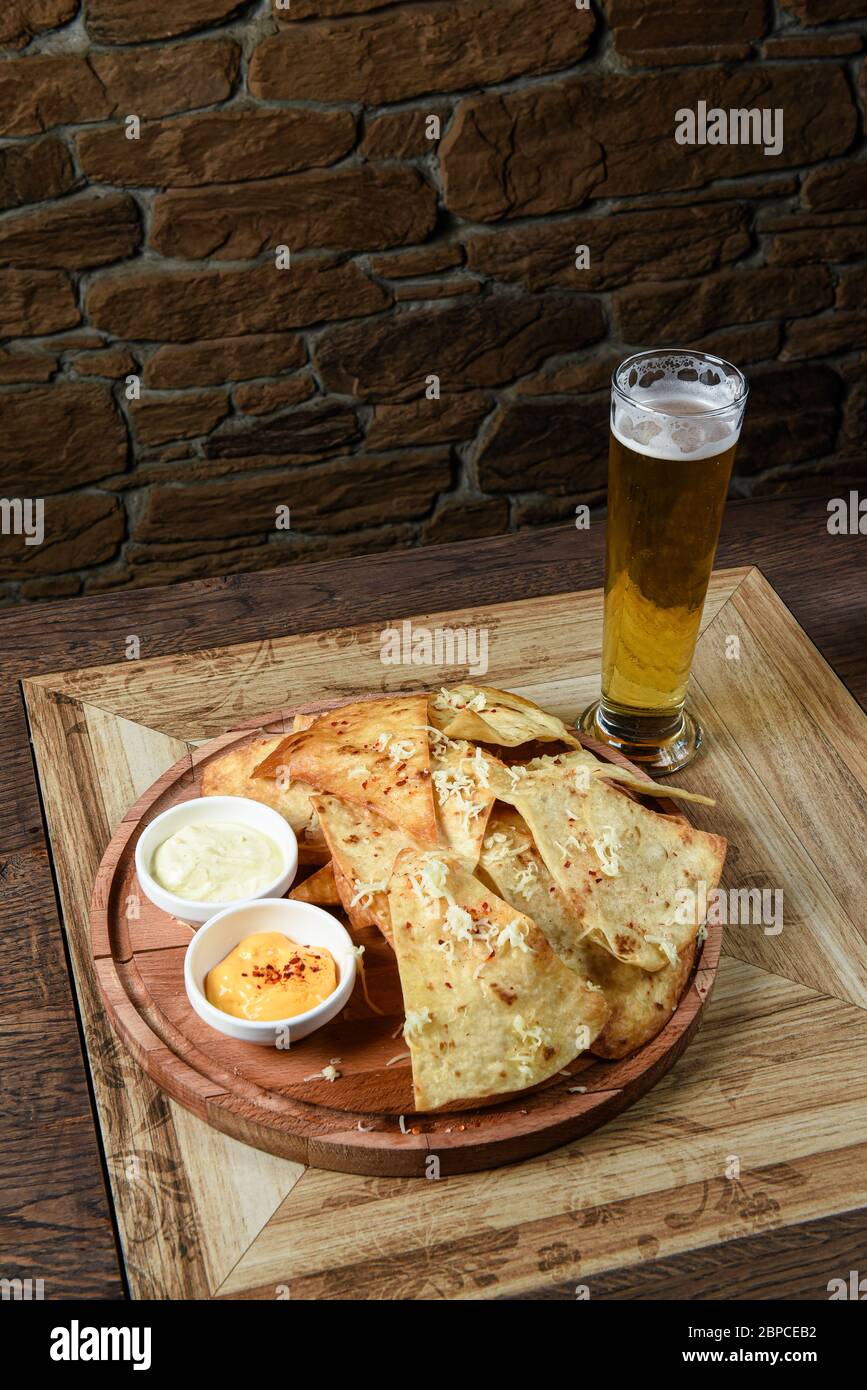 crispy fresh tortilla chips with sauces Stock Photo