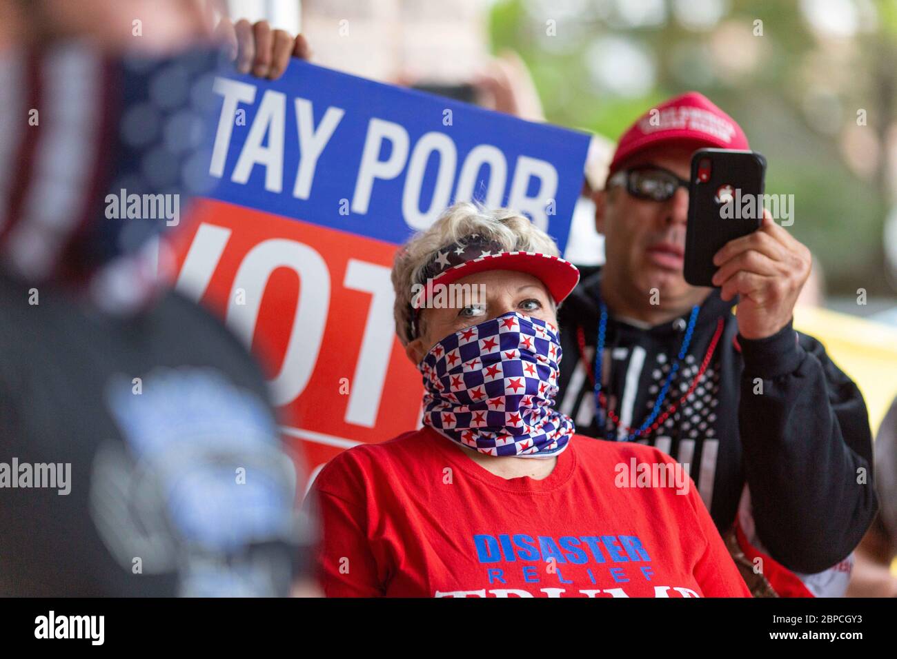 Bellmawr, New Jersey, USA. 18th May, 2020. A woman listens as the owners of the Atilis Gym in Bellmawr, NJ, speak to the public, on Monday, May 18, 2020. Credit: Dave Hernandez/ZUMA Wire/Alamy Live News Stock Photo