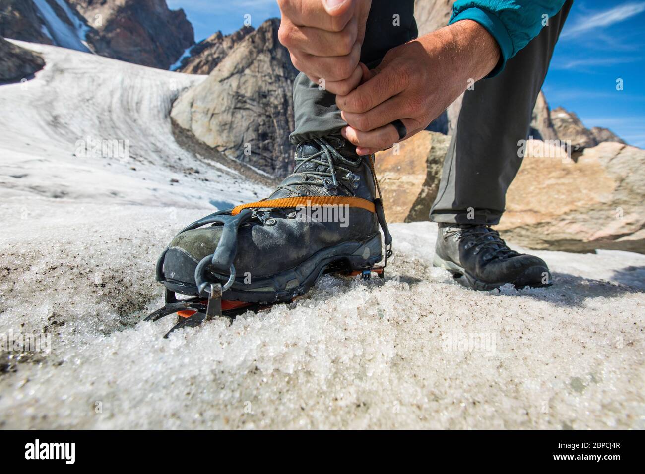 Detailed view of climber tightening his crampon before climbing Stock Photo  - Alamy
