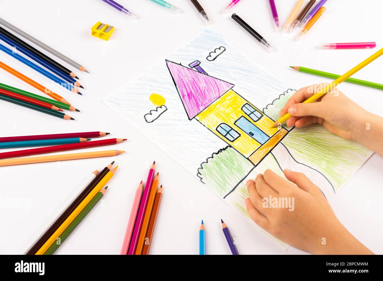 A child draws a house. Homemade creativity. Stock Photo