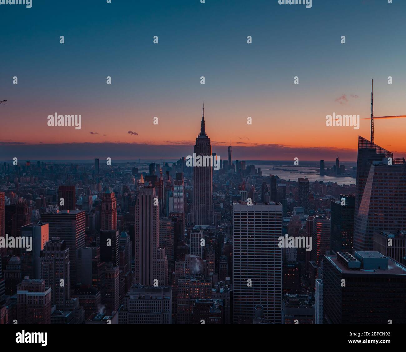 New York City Manhattan skyline at sunset with empire state building ...