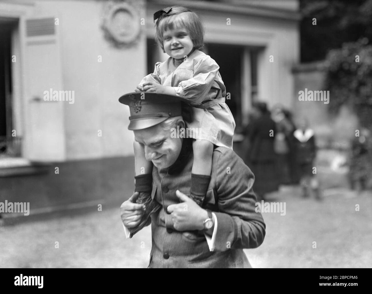 Little Belgian Refugee Girl having on Shoulders of American Red Cross Man at American Hostel for Refugees, 46 Rue du Dr. Blanche, Paris, France, Lewis Wickes Hine, American National Red Cross Photograph Collection, June 1918 Stock Photo