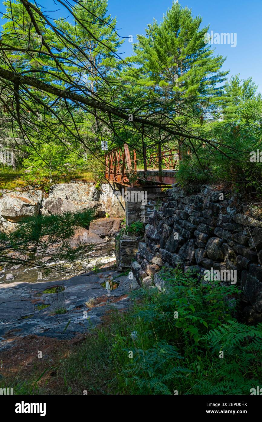 Victoria Falls Conservation Area  showing main bridge, two tone textured rocks and green forest on a sunny summer gorgeous day Stock Photo