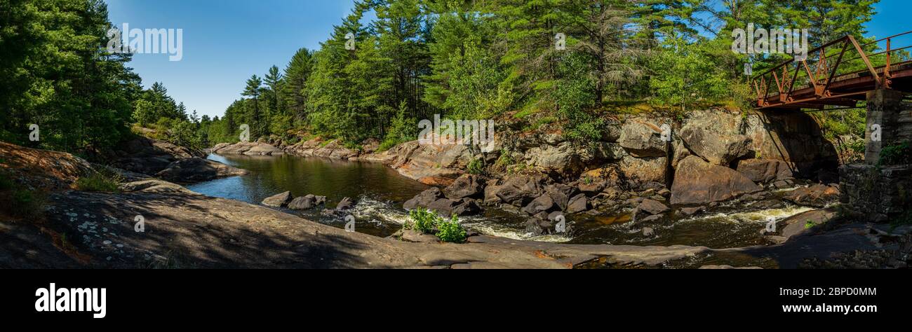 Victoria Falls Conservation Area  showing main bridge, two tone textured rocks and green forest on a sunny summer gorgeous day Stock Photo