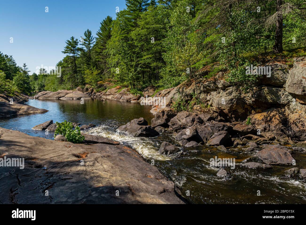 Victoria Falls Conservation Area  showing main falls area, two tone textured rocks and green forest on a sunny summer gorgeous day Stock Photo