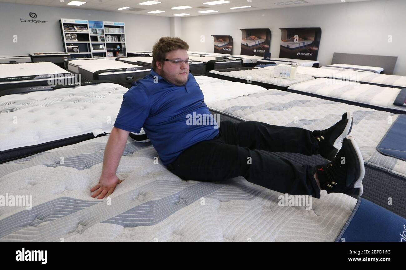 Richmond Heights, United States. 18th May, 2020. Sales person Drew Murphy tries out a new mattress on the show room floor at Mattress Giant in Richmond Heights, Missouri on Monday, May 18, 2020. The store was closed for over two month due to the coronavirus stay at home orders given by Missouri Governor Mike Parson. Photo by Bill Greenblatt/UPI Credit: UPI/Alamy Live News Stock Photo