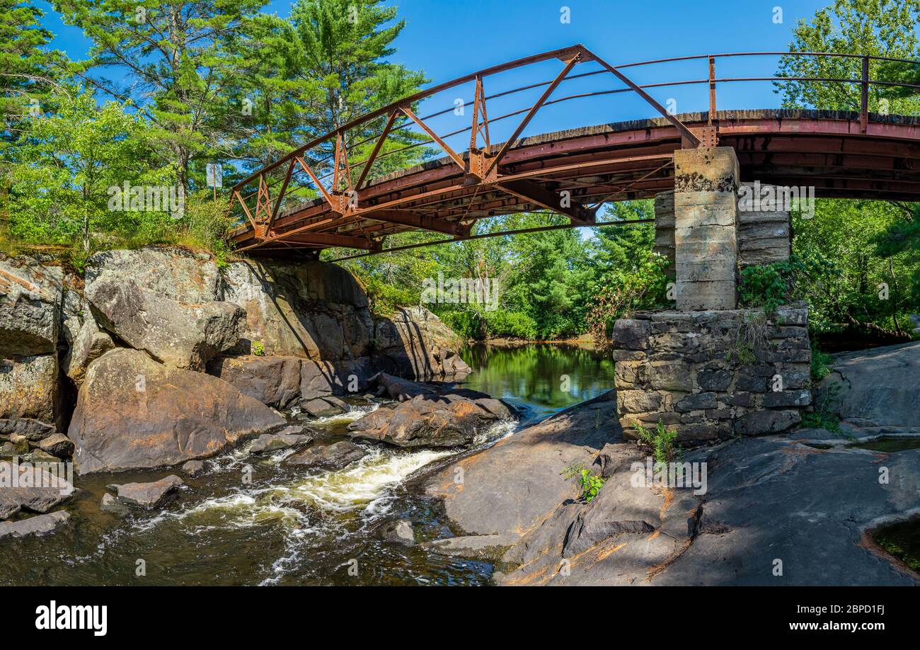 Victoria Falls Conservation Area  showing main bridge, two tone textured rocks and green forest on a sunny summer gorgeous day Stock Photo