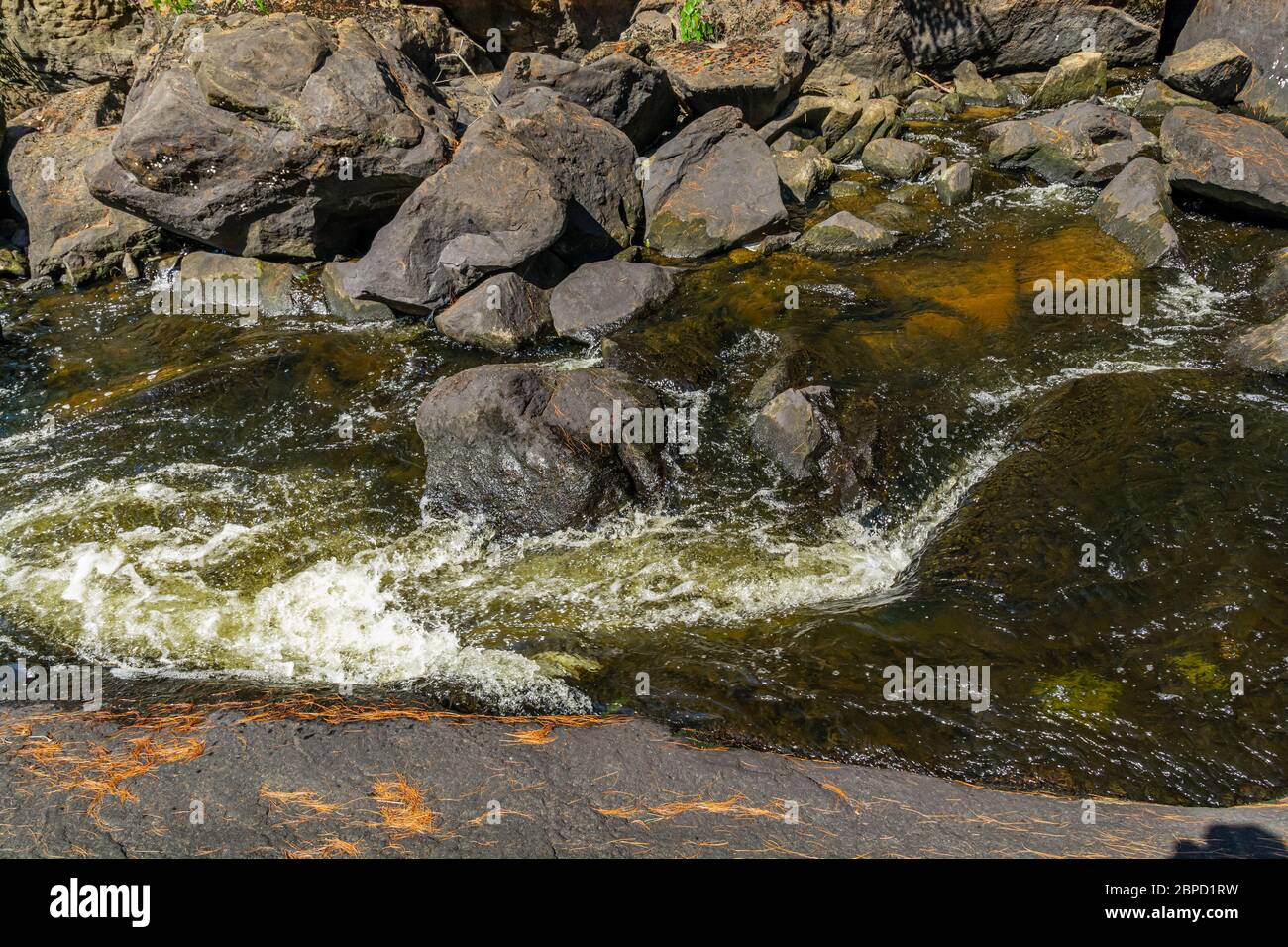 Victoria Falls Conservation Area  showing main falls area, two tone textured rocks and green forest on a sunny summer gorgeous day Stock Photo