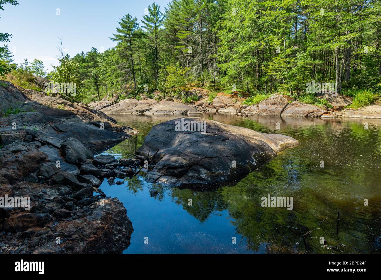 Victoria Falls Conservation Area  showing main falls area, two tone textured rocks and green forest on a sunny summer gorgeous day Stock Photo