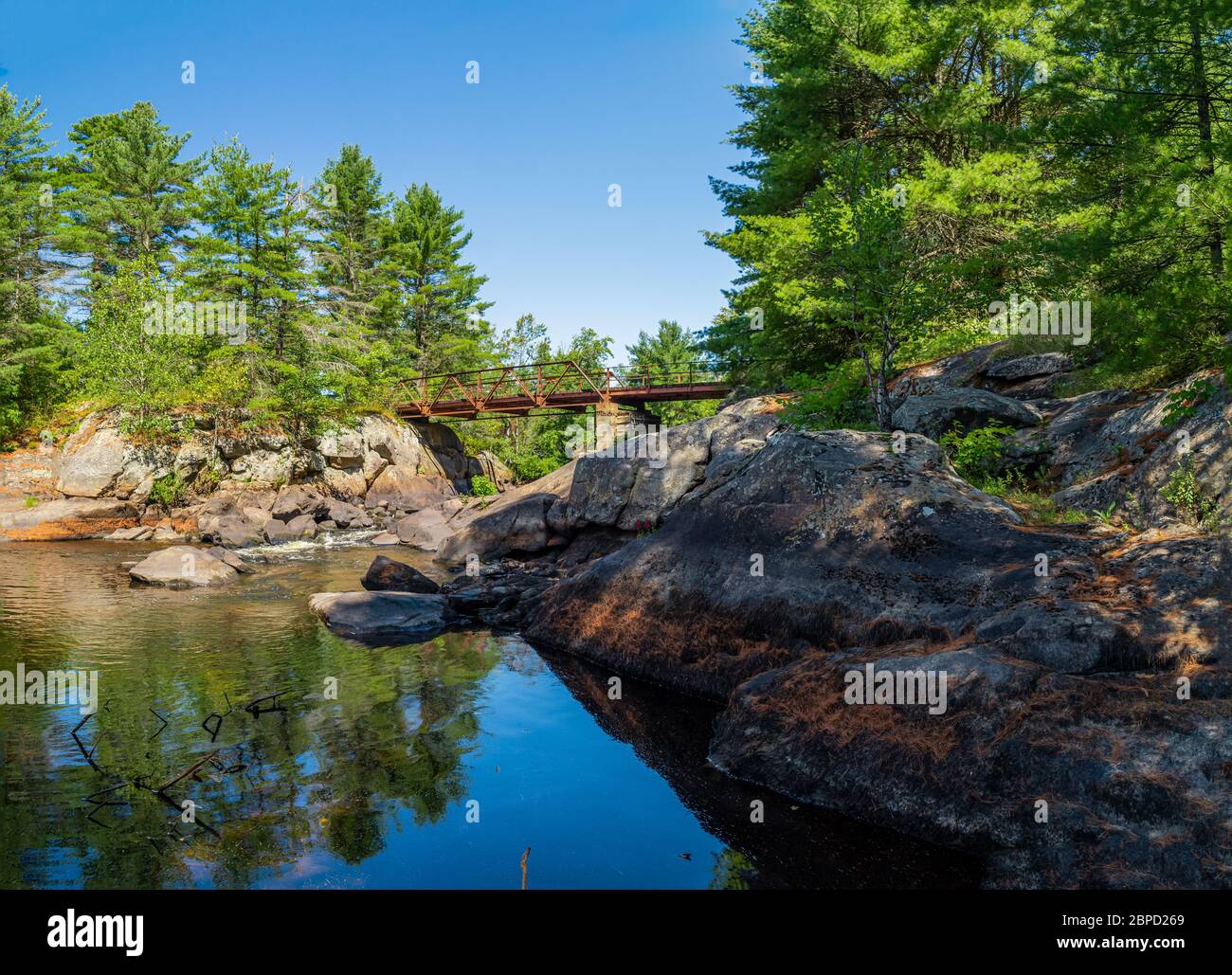 Victoria Falls Conservation Area  showing main bridge, two tone textured rocks and green forest on a sunny summer gorgeous day Stock Photo