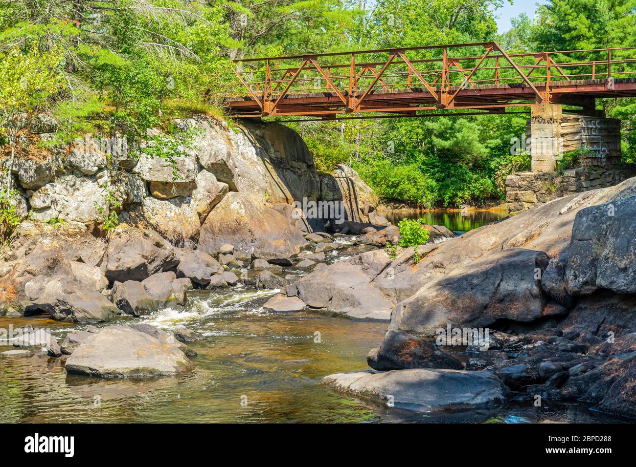 Victoria Falls Conservation Area  showing main bridge, two tone textured rocks and green forest on a sunny summer gorgeous day Stock Photo