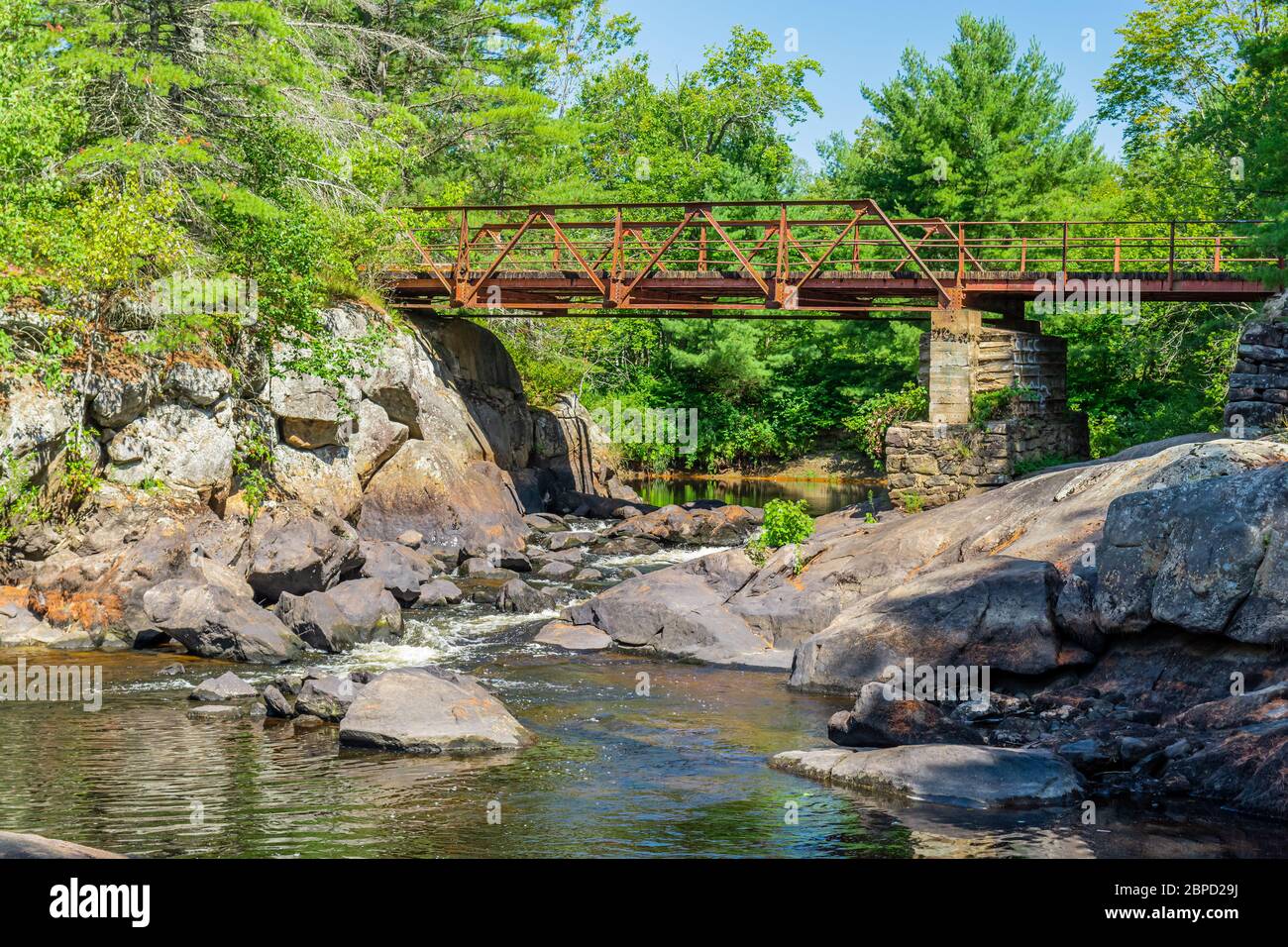 Victoria Falls Conservation Area  showing main bridge, two tone textured rocks and green forest on a sunny summer gorgeous day Stock Photo