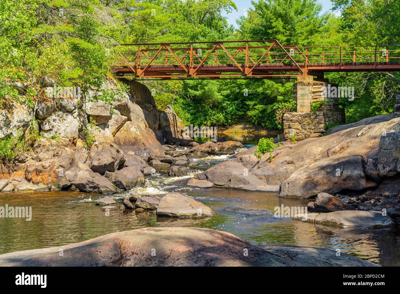 Victoria Falls Conservation Area  showing main bridge, two tone textured rocks and green forest on a sunny summer gorgeous day Stock Photo