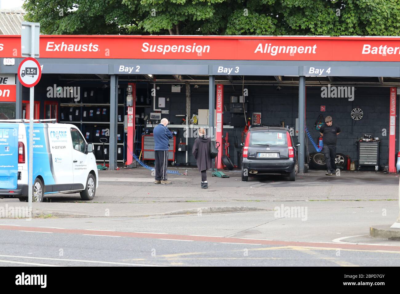 (200519) -- DUBLIN, May 19, 2020 (Xinhua) -- People are seen at a repair shop for cars in Dublin, Ireland, May 18, 2020. Ireland on Monday entered into what it called Phase-One stage in easing the restrictions which were imposed some 50 days ago following the COVID-19 outbreak in the country. During the stage, more businesses are allowed to be reopened in the country. They include hardware stores, homeware shops, garden centers, farmers' markets, repair shops for cars, motorbikes and bicycles, and optical shops. Restaurants like McDonald's and Burger King are also permitted to provide drive Stock Photo