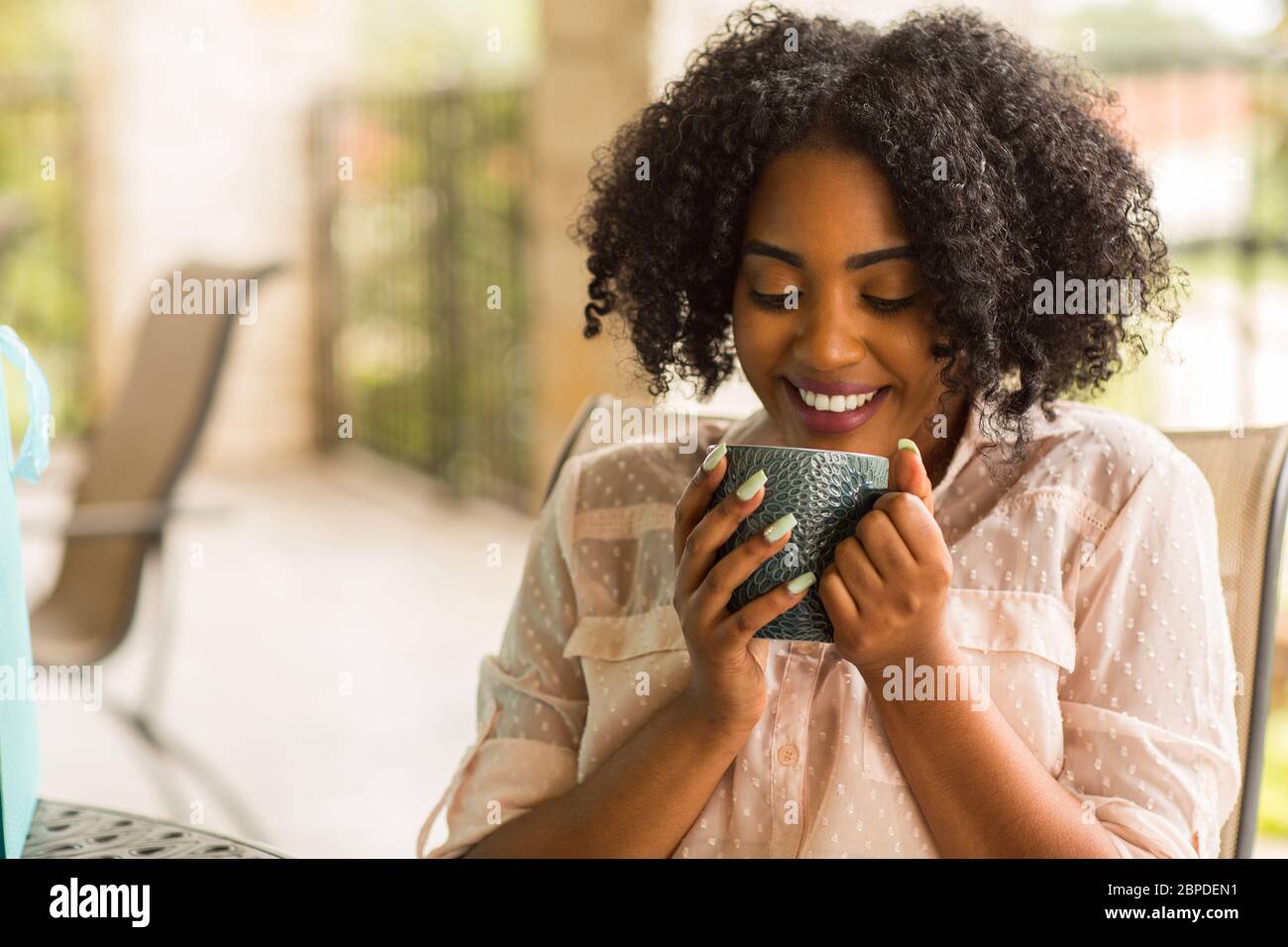 Portrait of an African American woman drinking coffee Stock Photo - Alamy