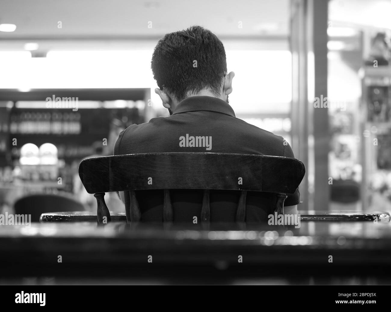 Back of young man sitting on the chair background Stock Photo Alamy