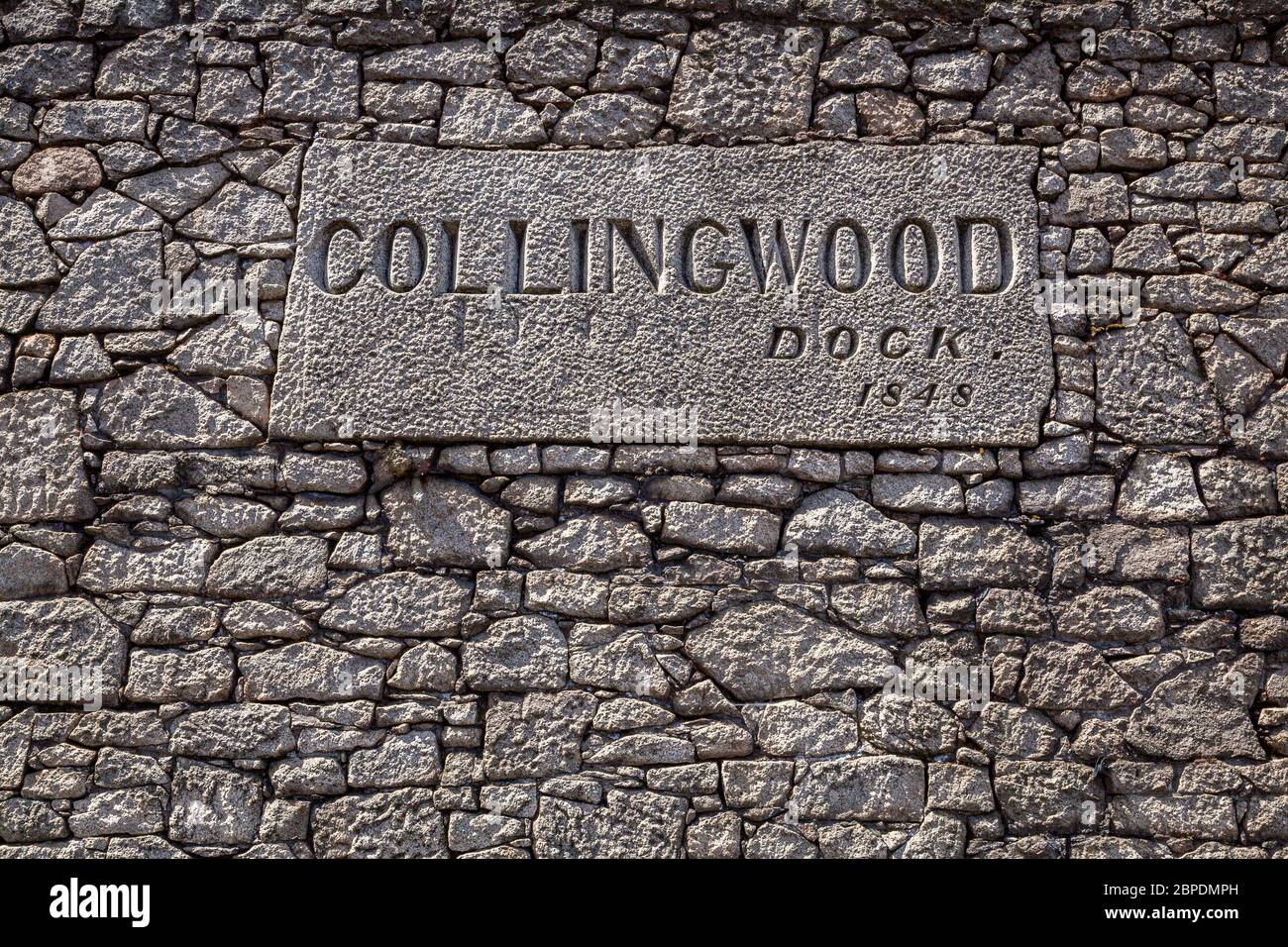 Sign on the old stone wall of the Collingwood Dock, part of the Port of Liverpool, England Stock Photo