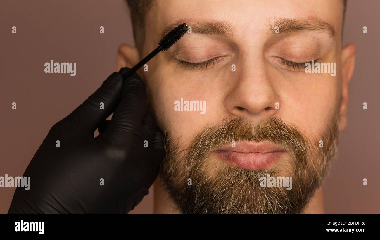 Correction shape of man eyebrow. Combing eyebrows and giving direction of hair growth. Work of master barber, Brow care concept Stock Photo - Alamy Correction shape of man eyebrow. Combing eyebrows and giving direction of hair growth. Work of master barber, Brow care concept Stock Photo - Alamy