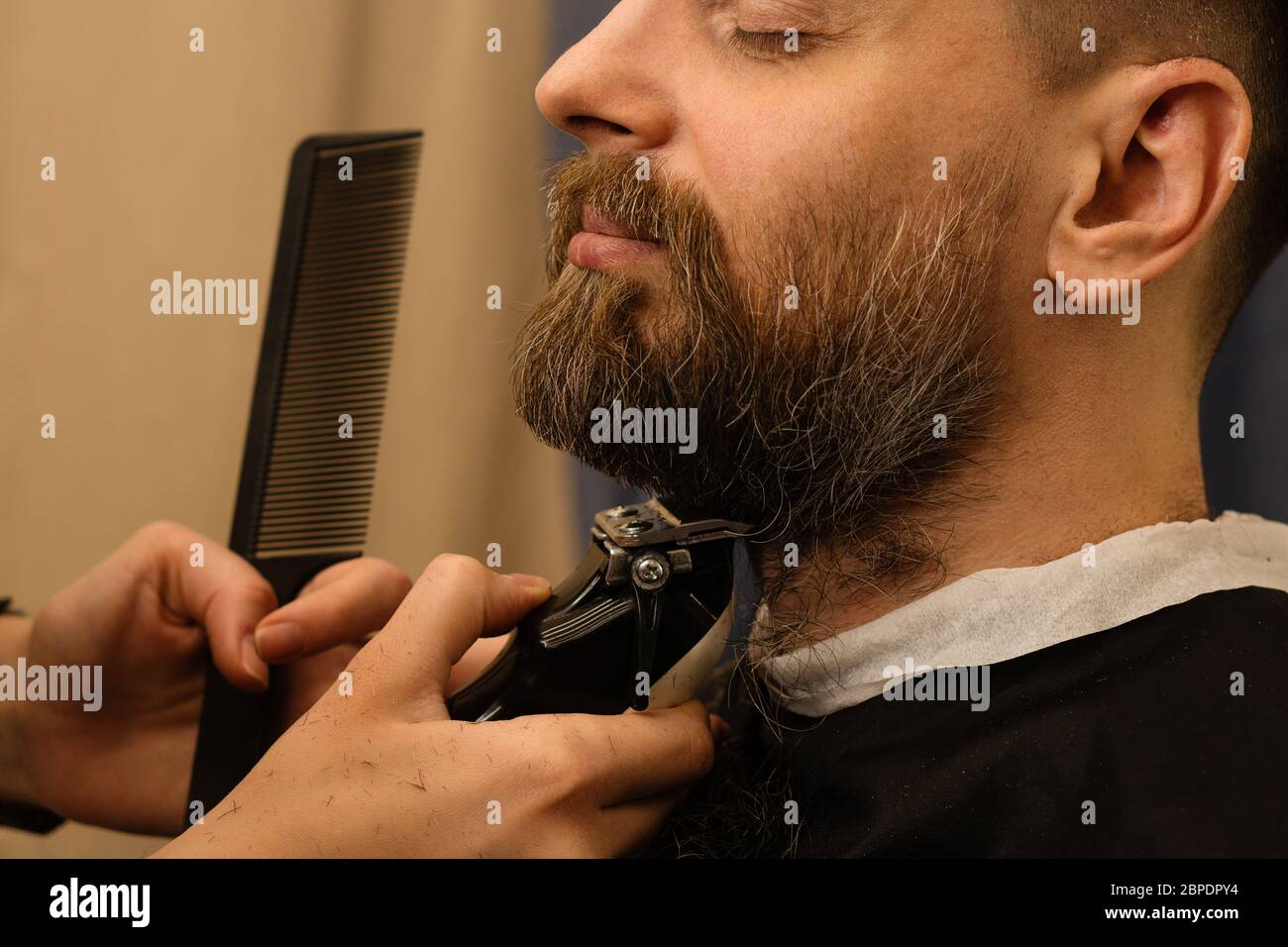 trim beard with comb and razor