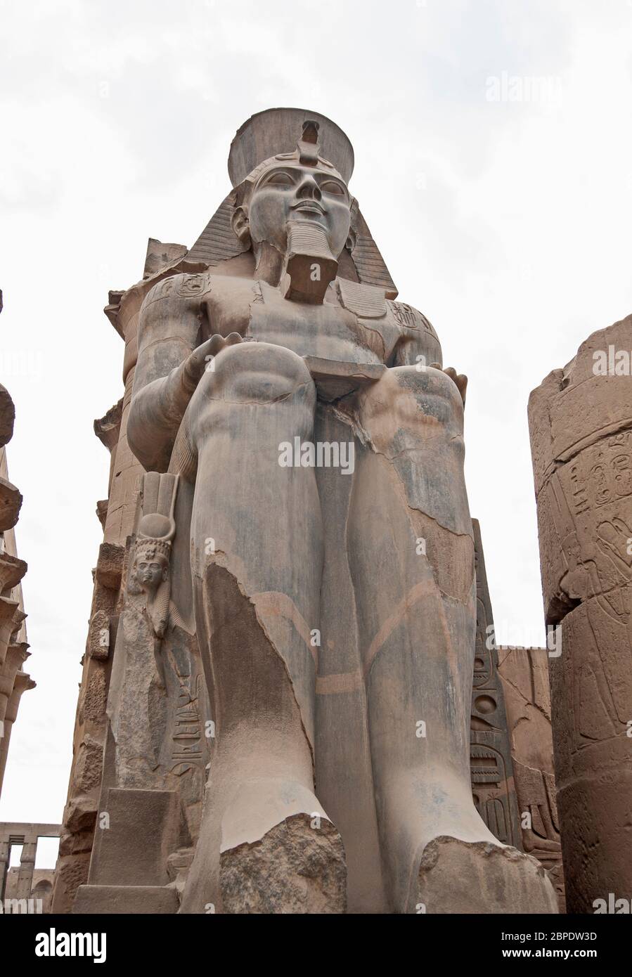 Large statue and hieroglypic carvings of Ramses II at the ancient egyptian Luxor temple isolated on white background Stock Photo
