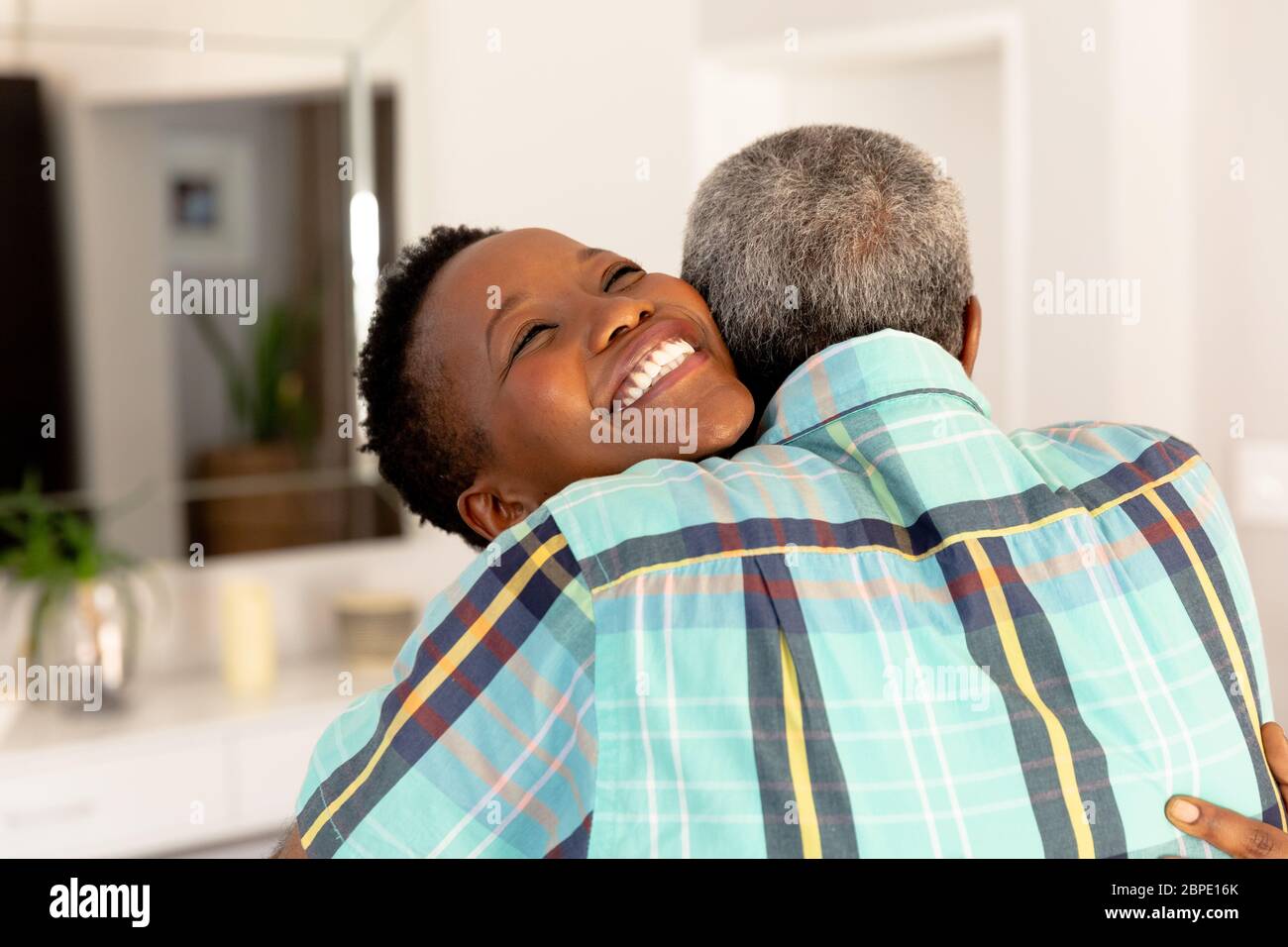 Senior African American couple embracing, smiling and looking at camera Stock Photo