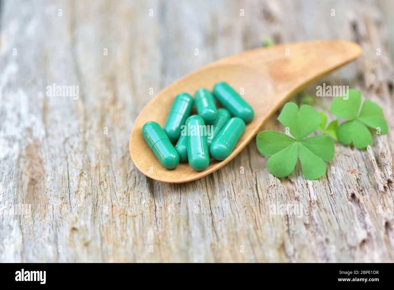 Herbal Medicines / Natural herb capsules Andrographis paniculata in spoon on wooden rustic background and copy space for using in medical background, Stock Photo