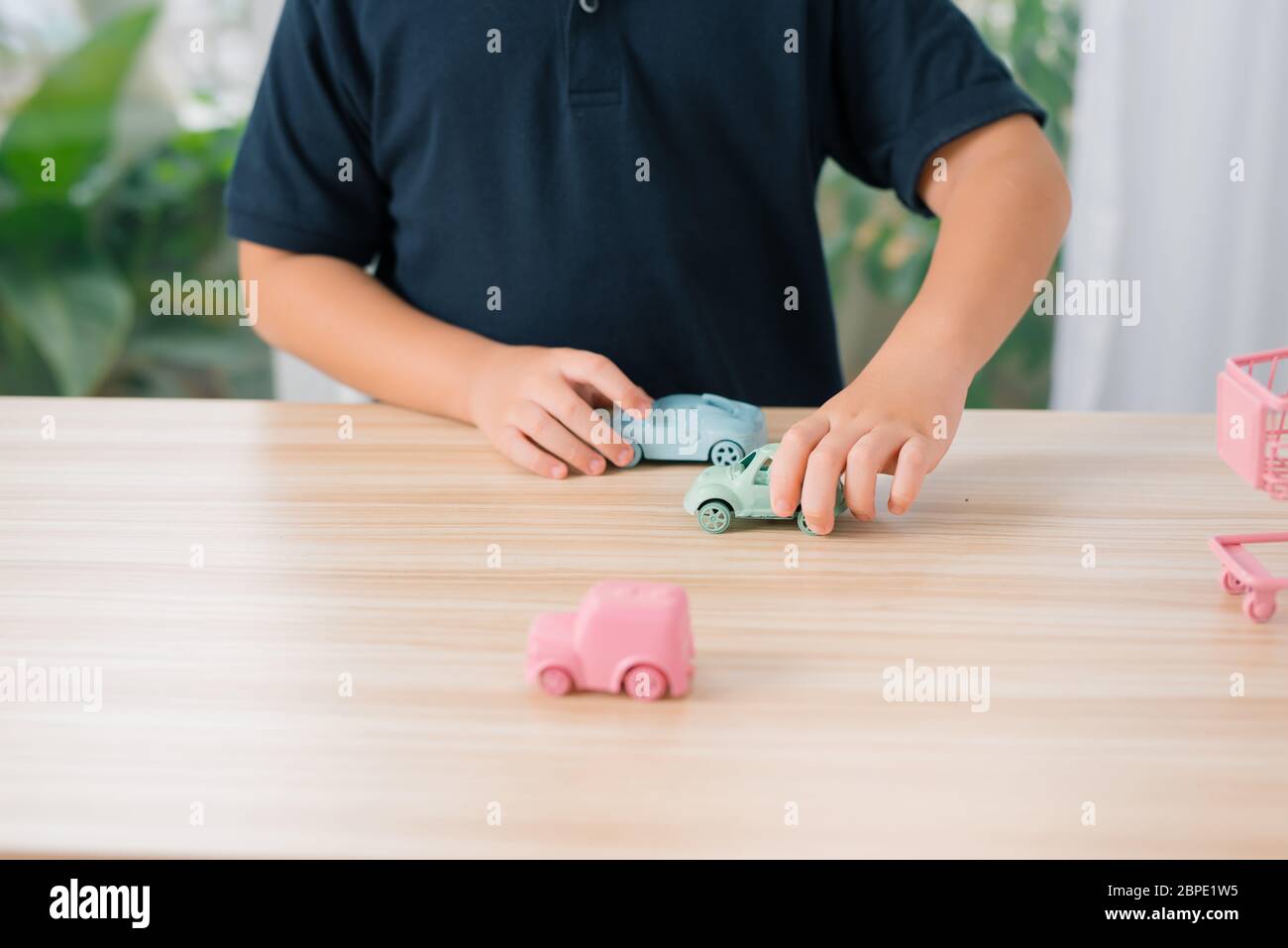 Little boy is playing with toy cars at home Stock Photo