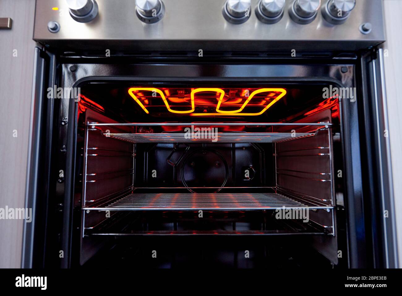 Empty hot oven with a flaming grill closeup Stock Photo Alamy