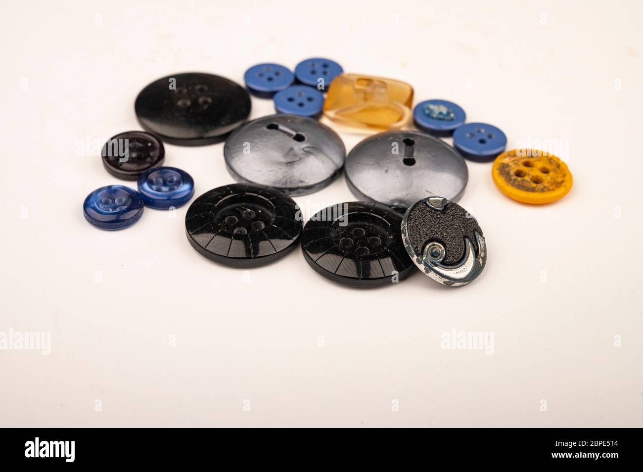 Several multi-colored buttons of different sizes on a white background ...